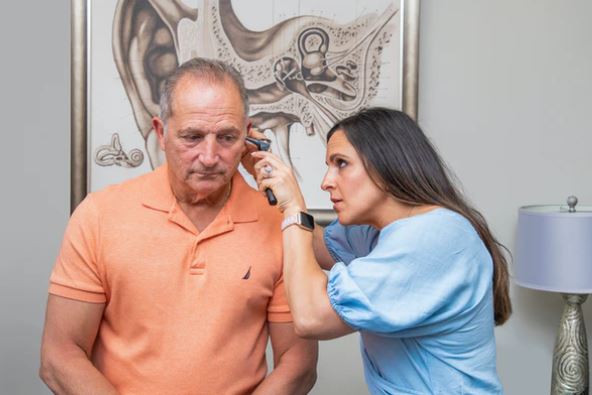 Dr. April Egarian performing an otoscopy exam