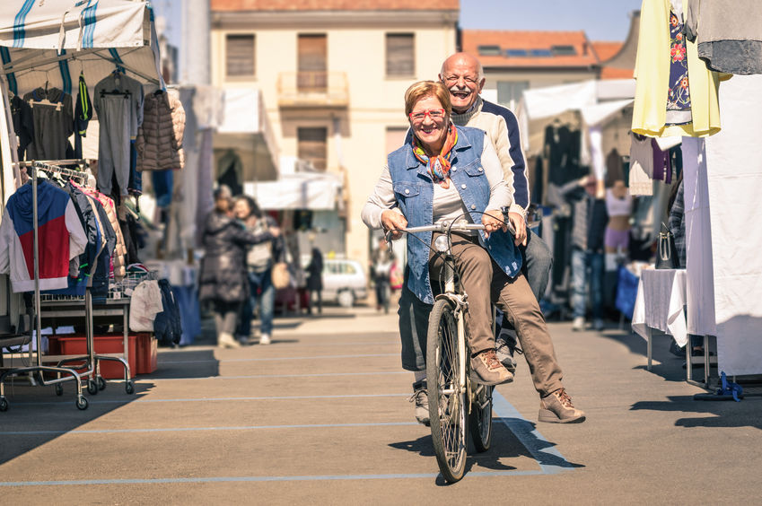 Couple riding a bike in an outdoor market